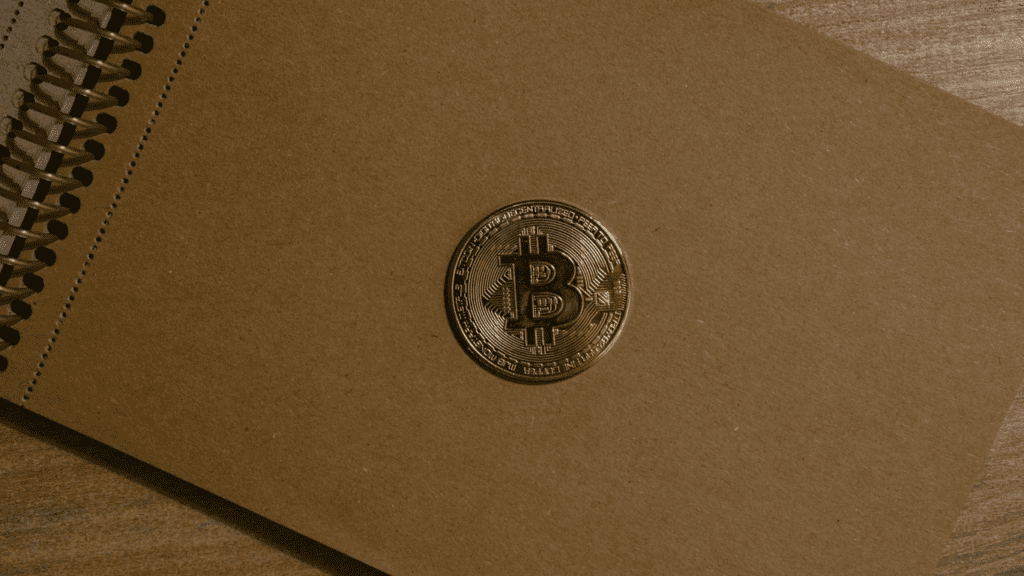 Brown notebook with bitcoin 